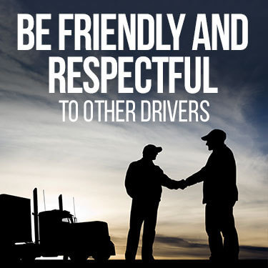 Two truck drivers displaying truck stop etiquette by shaking hands