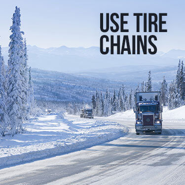 Two semi-trucks not using tire chains as suggested by our truck driving tips for mountain roads 
