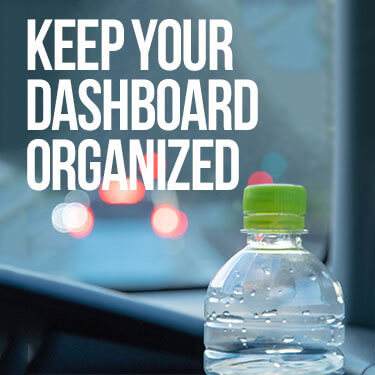 A bottle of water on a dashboard